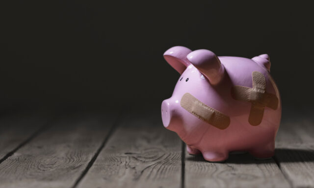 Broken piggy bank with band aid bandage or plaster finance background, representing calculating investment and providing bad financial advice.