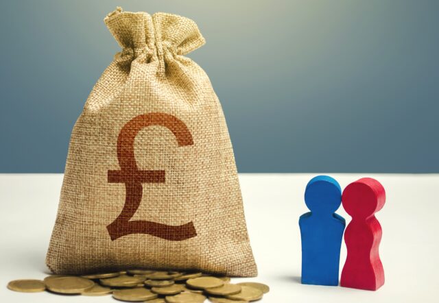 Couple figurines and british pound sterling money bag. Budget, consumer preferences. Investments, representing calculating investment and providing bad financial advice.