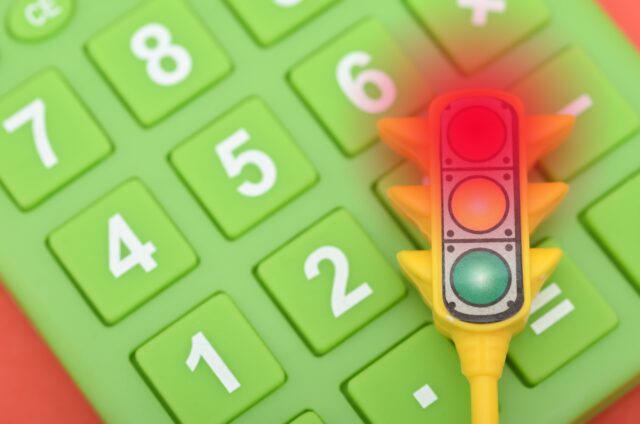 Red Alert on Calculator: Symbolising Financial Risk.