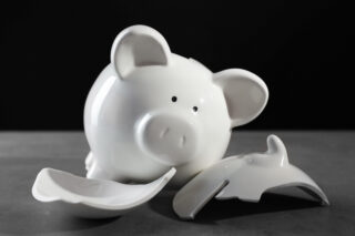 Broken piggy bank on the table symbolising Liberty SIPP claims.