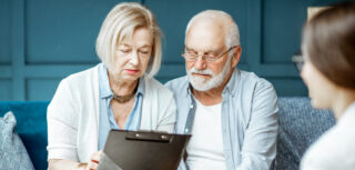 Client couple consulting adviser about pension advice concerns.