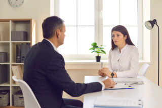 Financial adviser consulting with clients in office