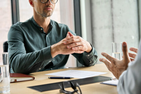 Two professionals in discussion or negotiation — conveying the value of resolving matters without court.
