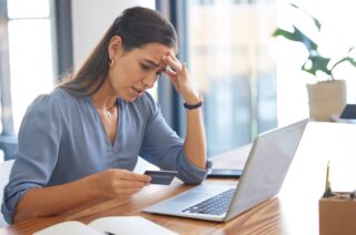 Credit card, stress woman with anxiety from investment scam.