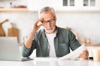 Person reviewing pension documents to submit mis-sold SIPP claim.