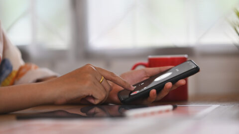 Person rejecting a video call on their phone to represent common romance scam warning signs.