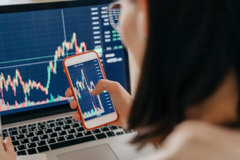 UK investor checking a fake crypto exchange app on their phone with warning signs of fraud