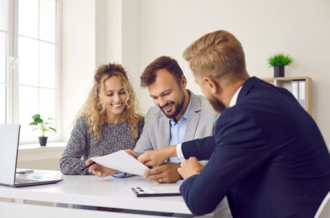 Solicitor and clients reviewing insurance paperwork, illustrating contributory negligence