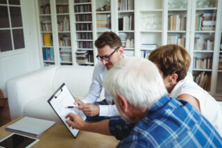 Senior couple discussing mis-sold investments for care home fees.