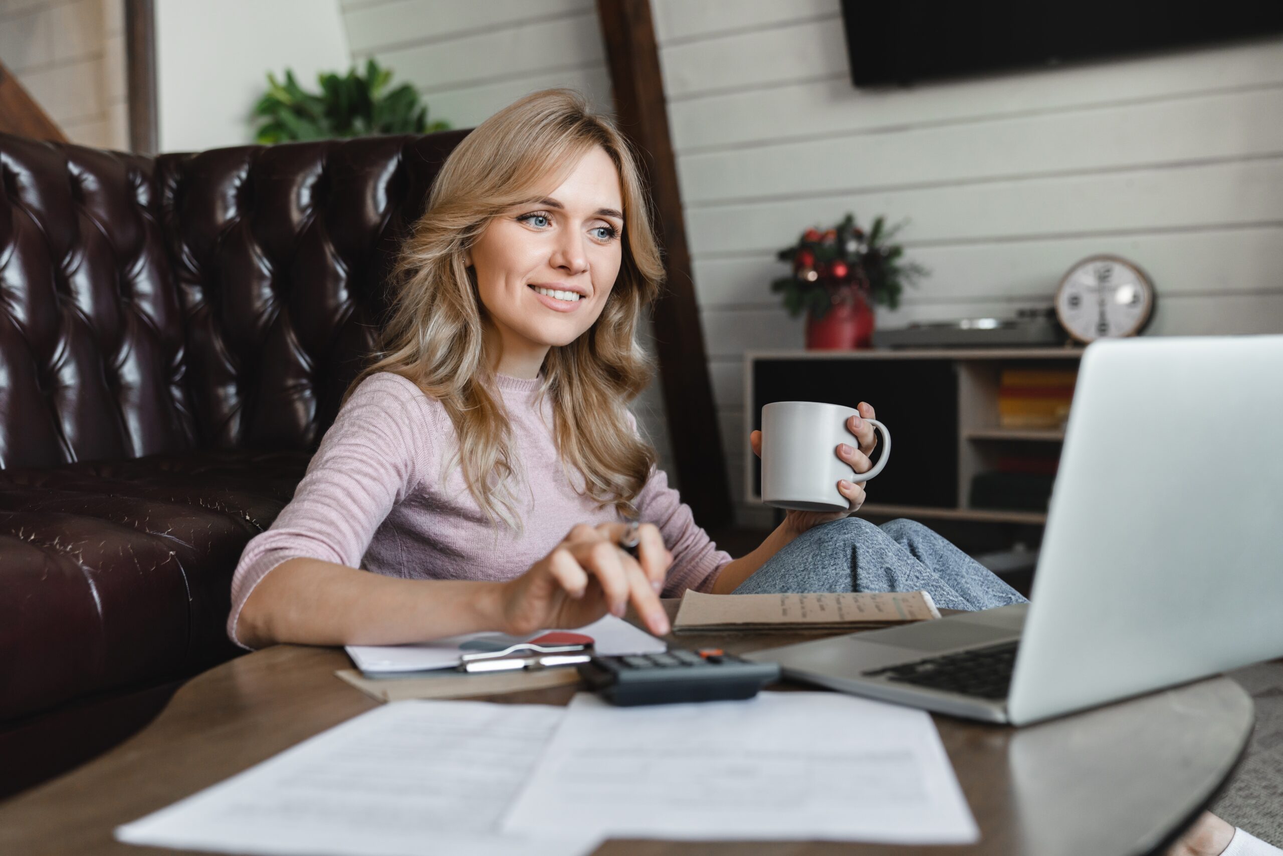 Client calculating potential ISA compensation with financial documents and calculator.