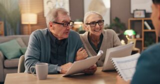 Couple discussing pension and retirement planning with a financial adviser