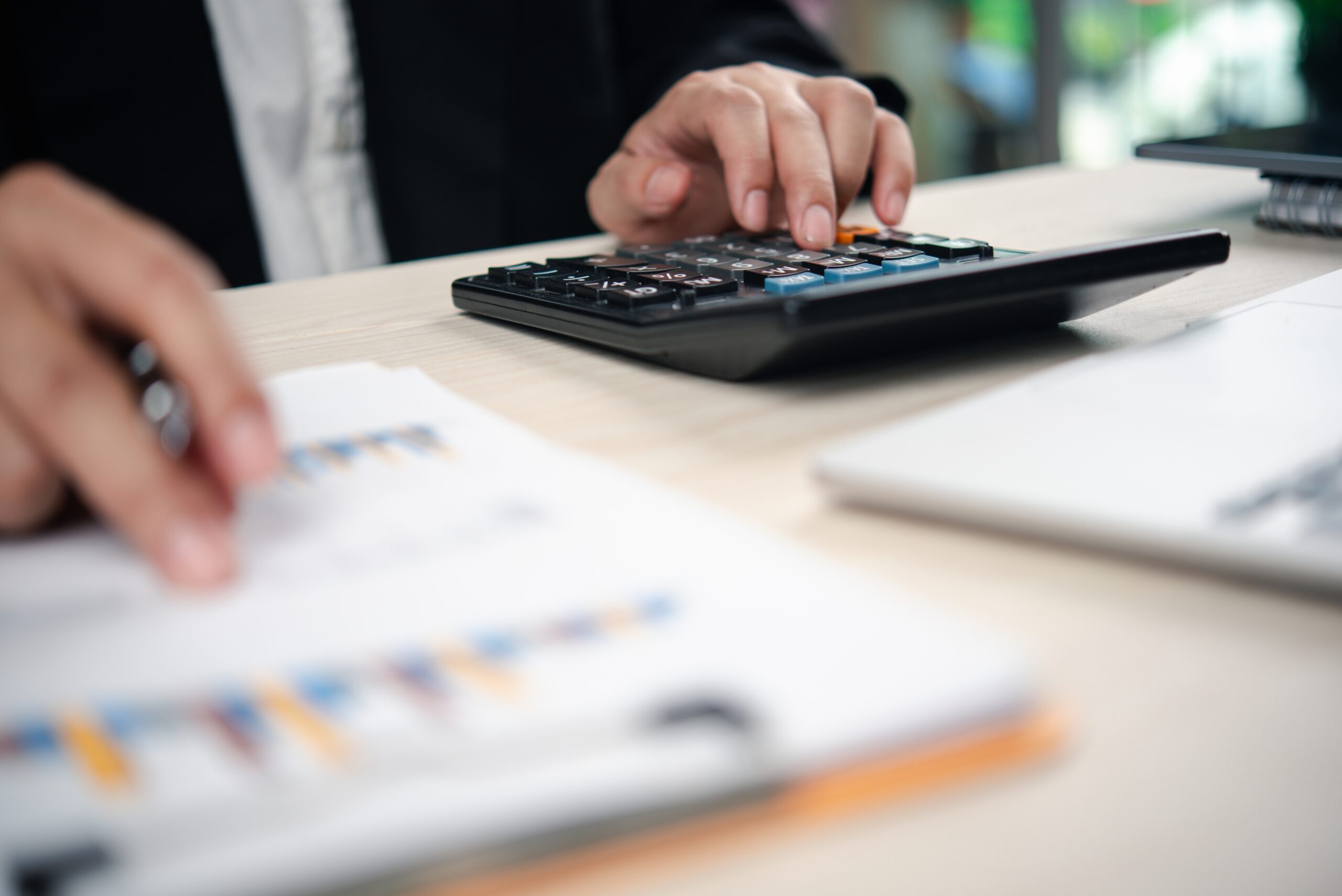 Calculator and financial documents on a desk