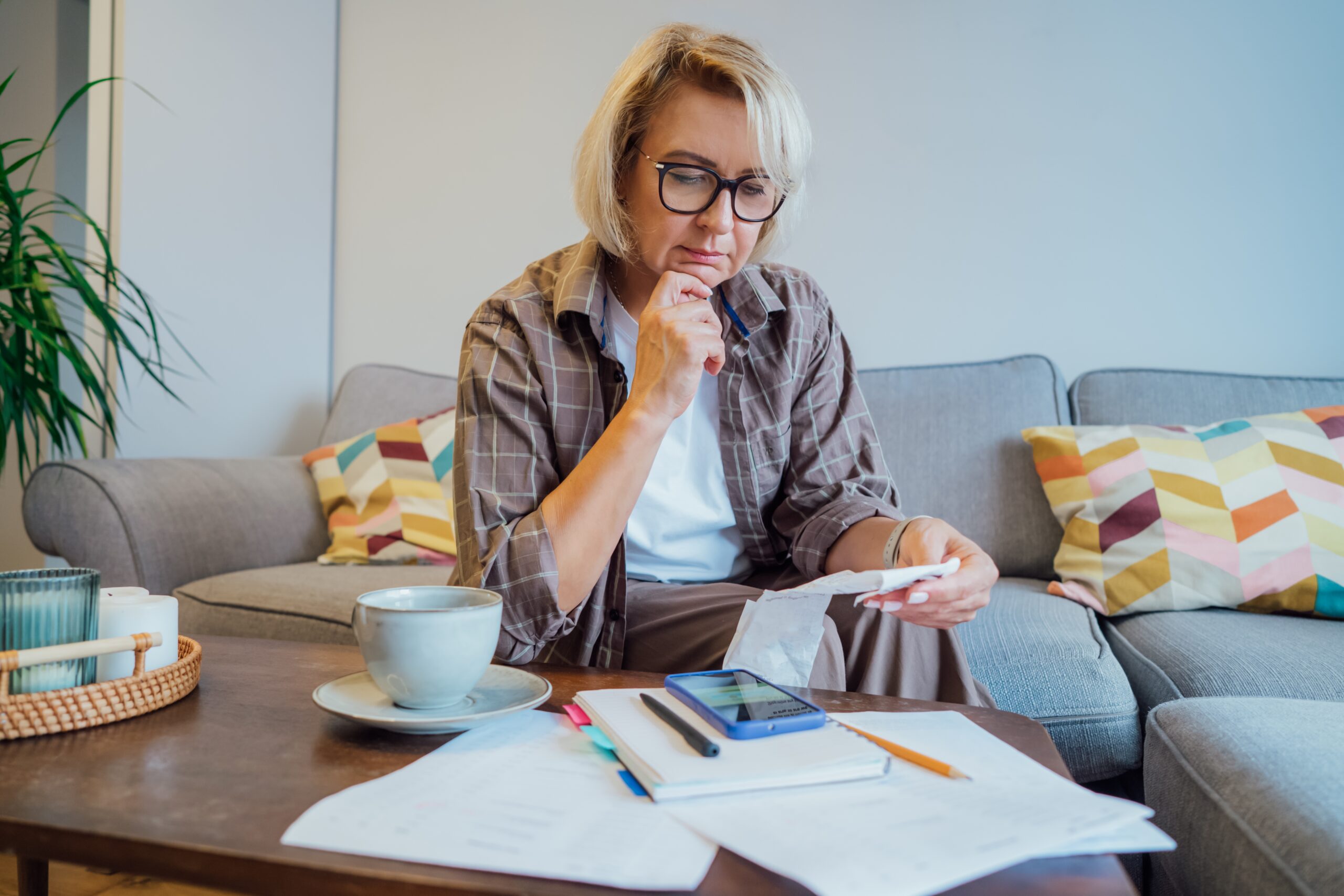 Person reviewing financial documents at home