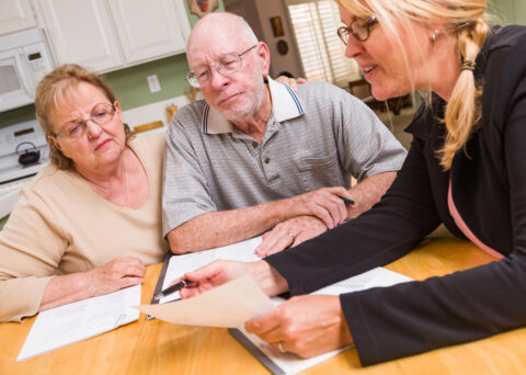 Calculator alongside pension or financial paperwork, or a professional working through figures.