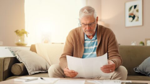 Person reviewing pension paperwork and dates