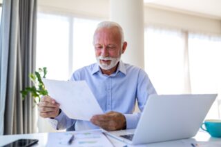 Older man reviewing pension paperwork