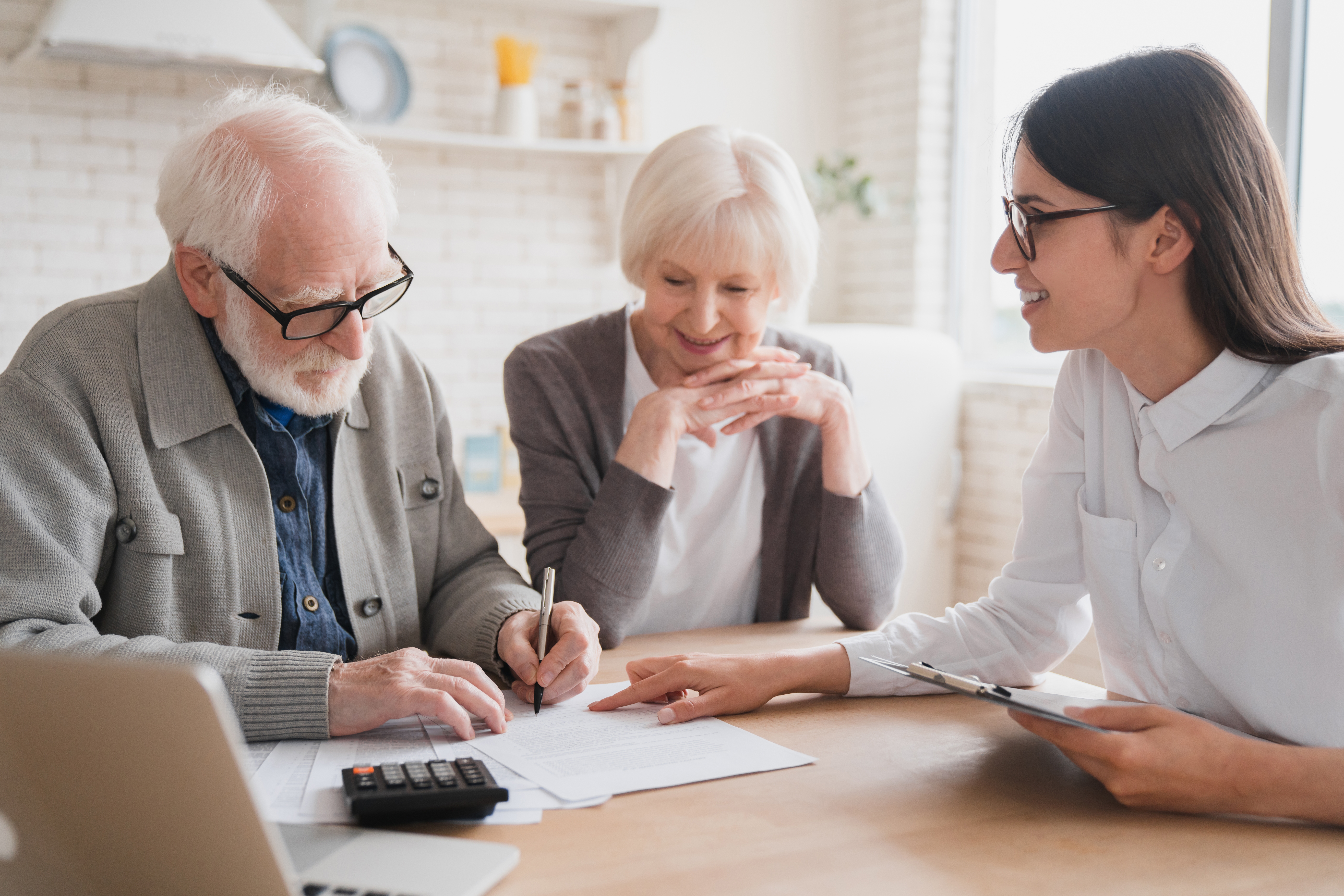 Older couple discussing retirement finances with a financial adviser