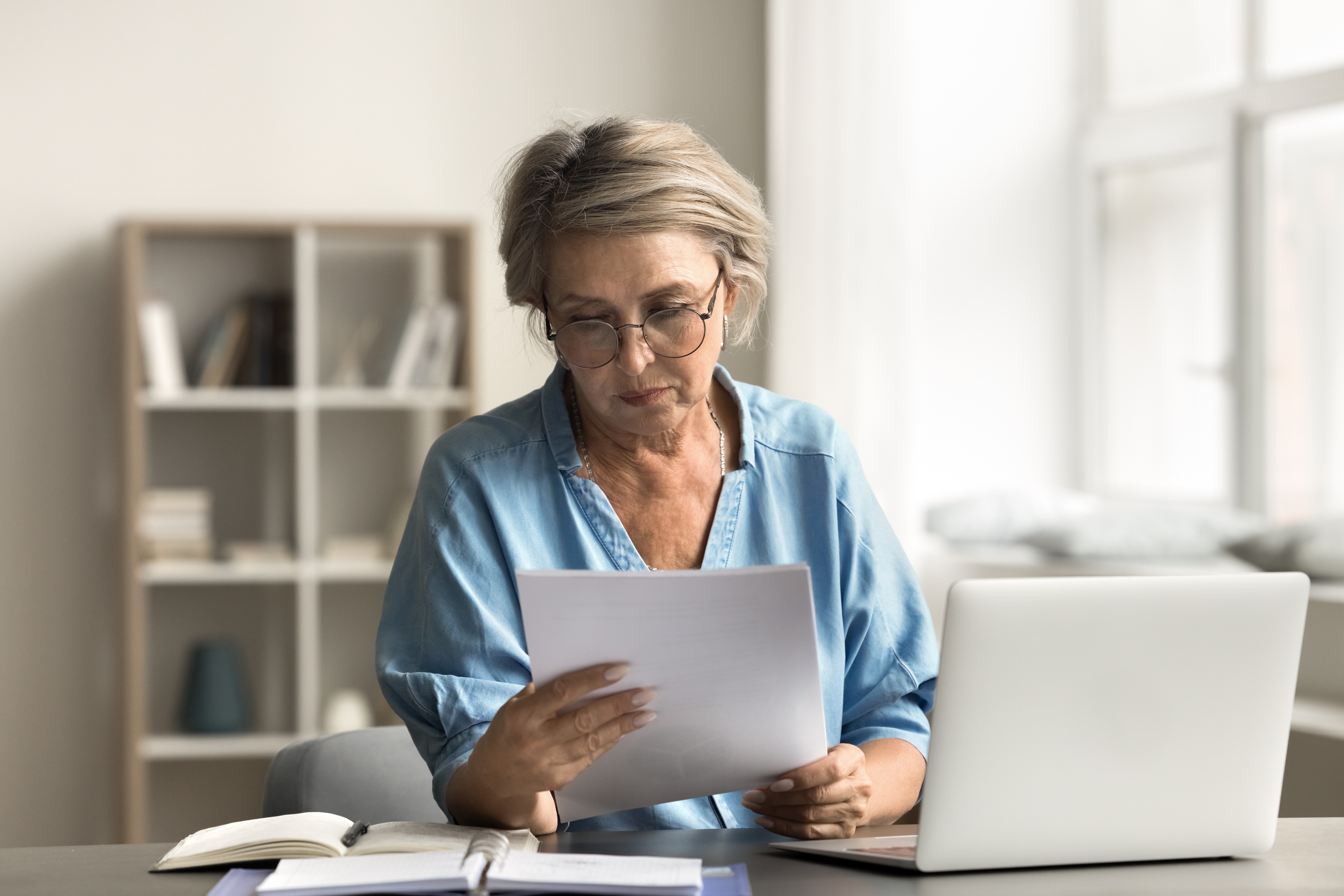 Older person reviewing a financial statement and looking concerned