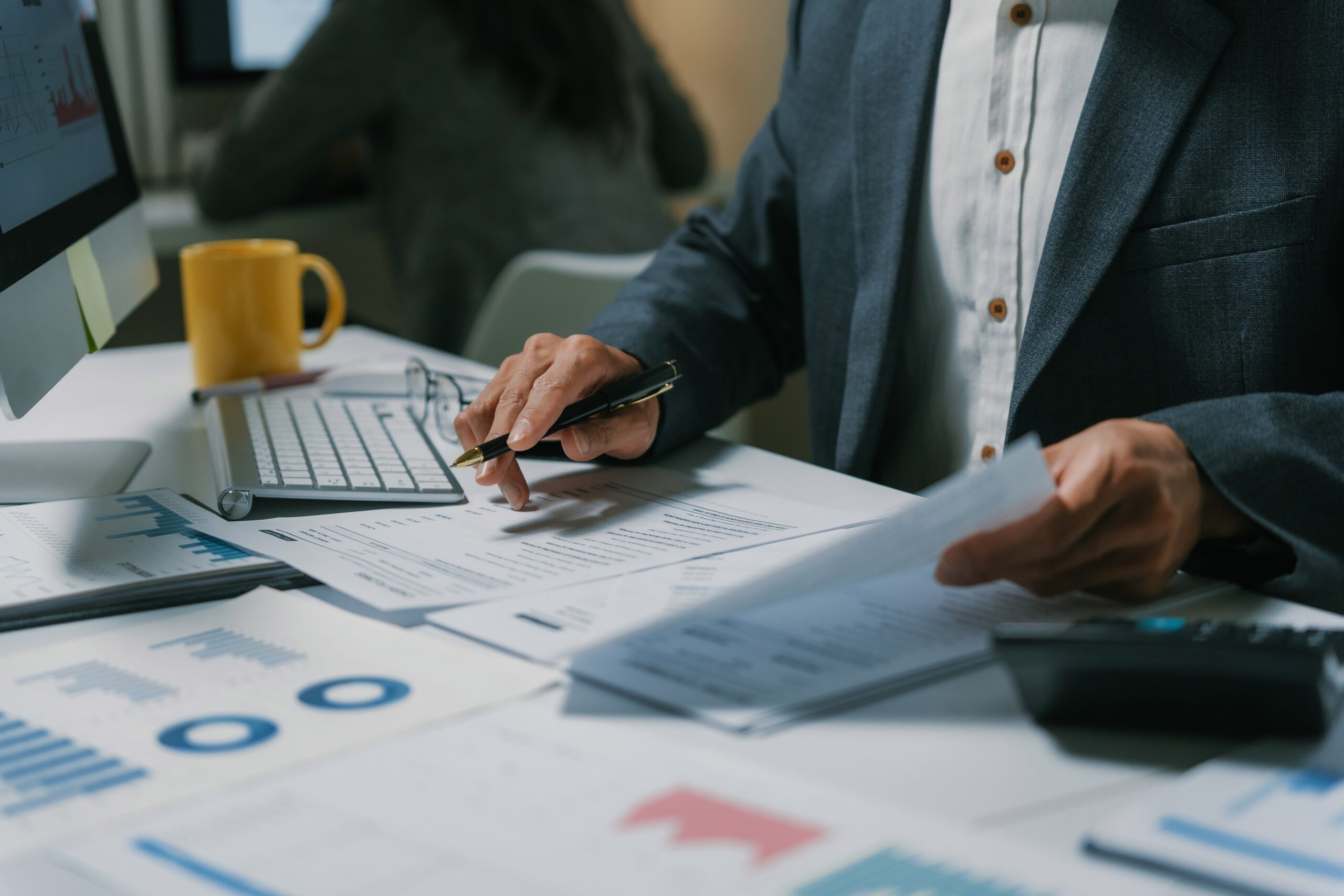 Person reviewing investment advice documents and financial paperwork