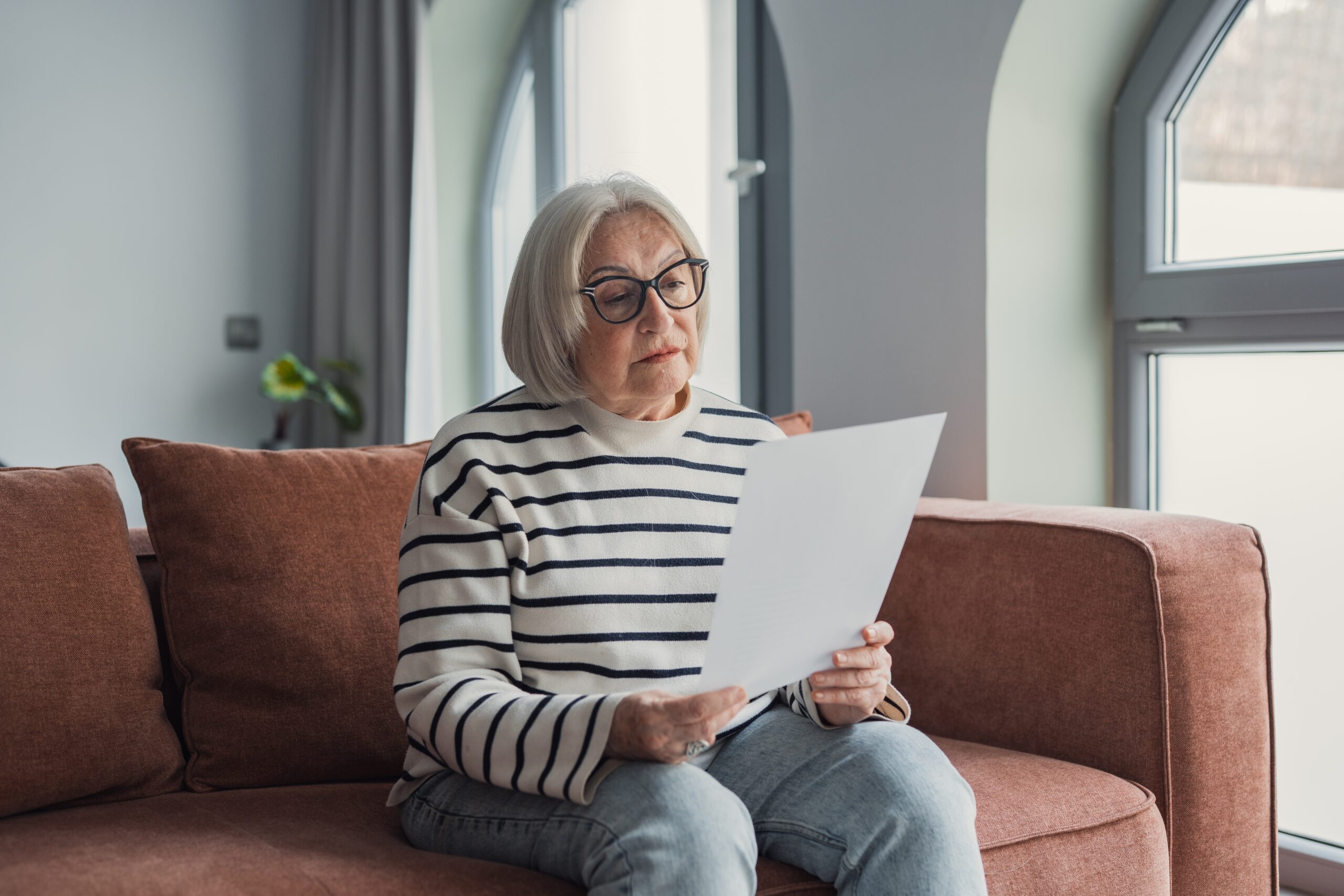Woman reviewing pension paperwork at home